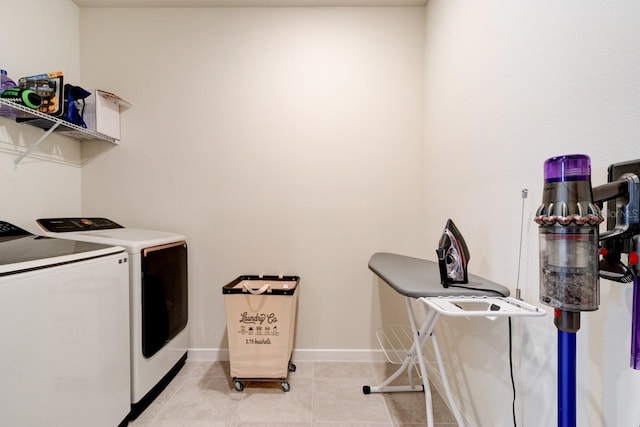 laundry area featuring separate washer and dryer and light tile patterned floors