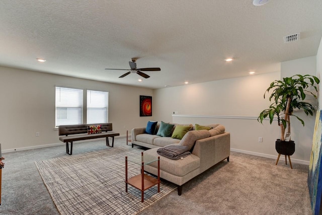 living room with light carpet, a textured ceiling, and ceiling fan