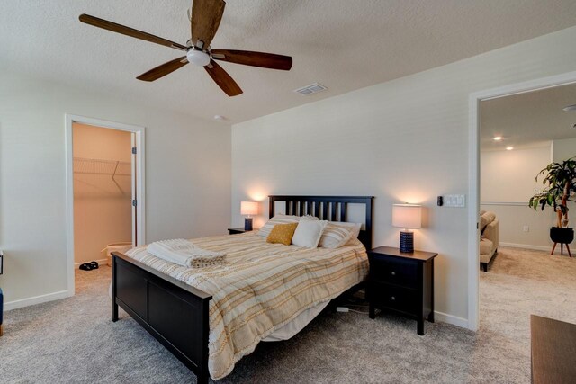 4009 Winding Meadows St, Apopka, FL 32712 - carpeted bedroom with a ceiling fan, visible vents, a textured ceiling, and a spacious closet