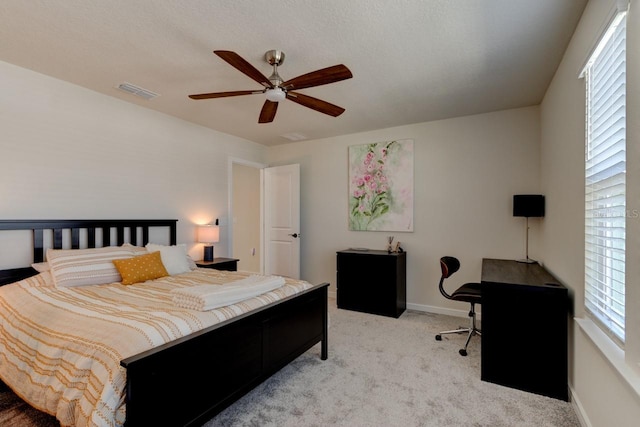 carpeted bedroom featuring a textured ceiling and ceiling fan