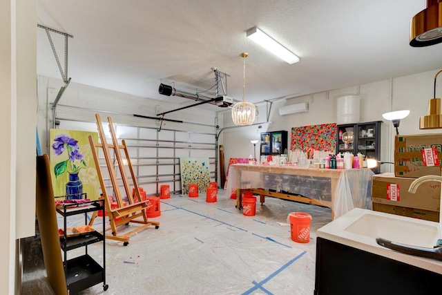 garage with an AC wall unit, sink, and a garage door opener