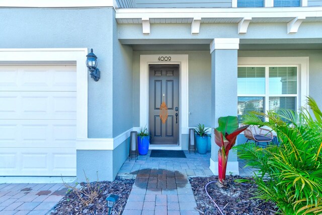 4009 Winding Meadows St, Apopka, FL 32712 - view of exterior entry featuring a garage and stucco siding