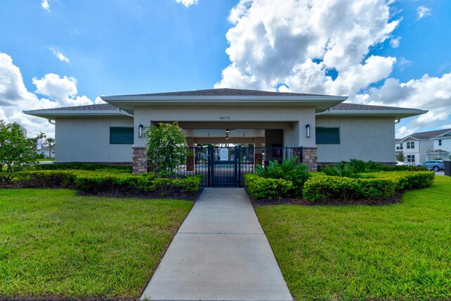 4009 Winding Meadows St, Apopka, FL 32712 - exterior space with stucco siding, a gate, fence, stone siding, and a front yard