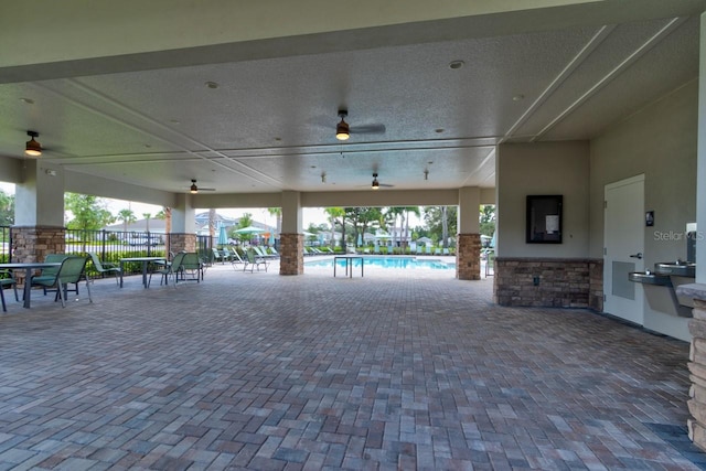 4009 Winding Meadows St, Apopka, FL 32712 - view of patio featuring fence, ceiling fan, a community pool, and an outdoor kitchen