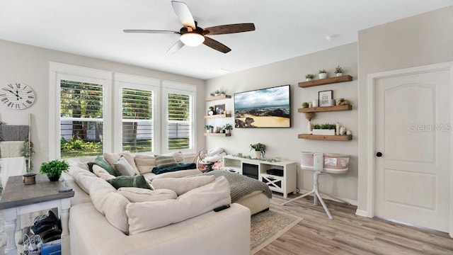 living room featuring light hardwood / wood-style flooring and ceiling fan