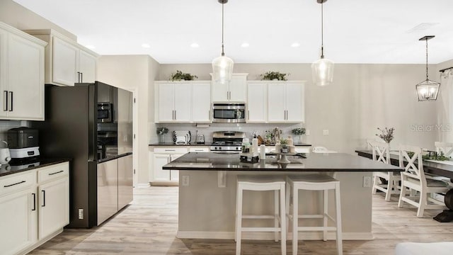 521 Morgan Wood Dr, Deland, FL 32724 - kitchen featuring stainless steel microwave, a center island, backsplash, range with gas cooktop, and freestanding refrigerator