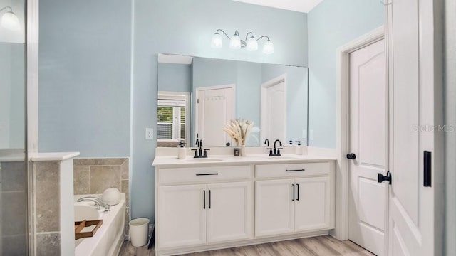 bathroom featuring vanity, a tub, and hardwood / wood-style floors