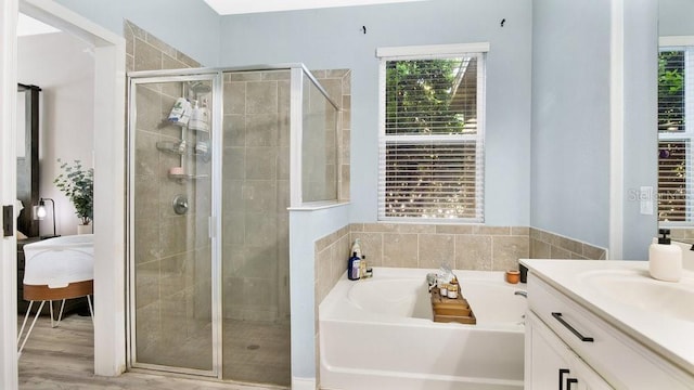 521 Morgan Wood Dr, Deland, FL 32724 - full bathroom with connected bathroom, a stall shower, a bath, wood finished floors, and vanity