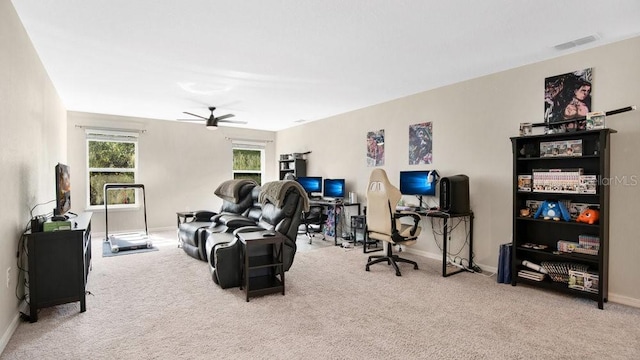 carpeted living room with ceiling fan