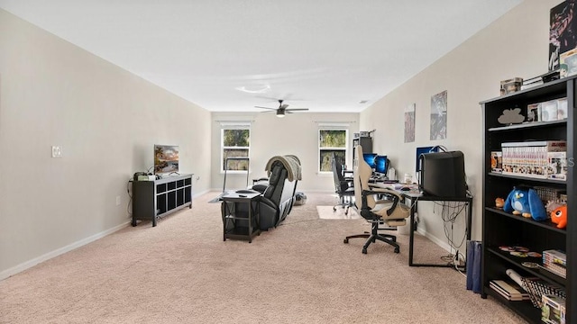 home office featuring light carpet and ceiling fan