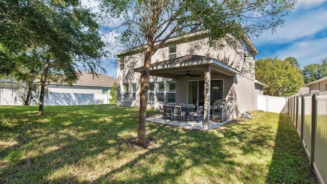 521 Morgan Wood Dr, Deland, FL 32724 - rear view of house with a fenced backyard, stucco siding, a yard, ceiling fan, and a patio area