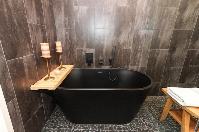 bathroom with tile walls and a washtub