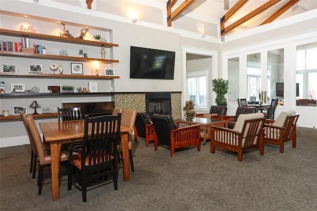 interior space featuring a wealth of natural light, beam ceiling, and high vaulted ceiling