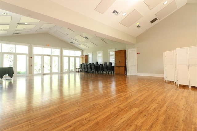 interior space featuring french doors, high vaulted ceiling, and light hardwood / wood-style floors