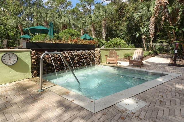 view of swimming pool with a hot tub and a patio area