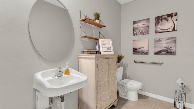 bathroom with toilet and tile patterned flooring