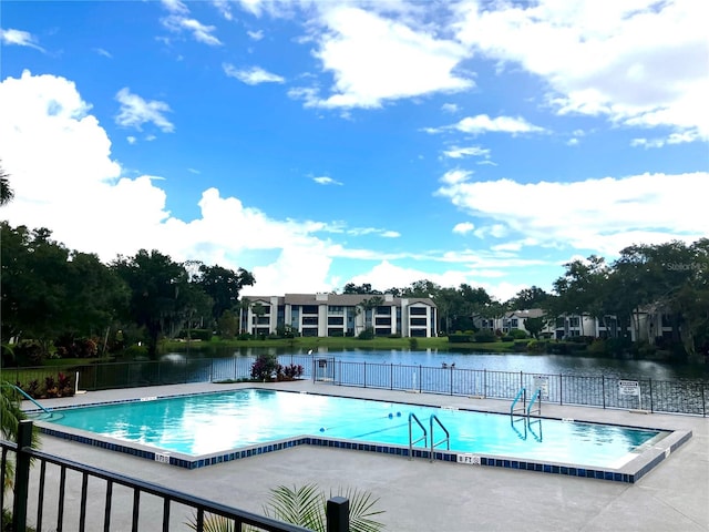 view of swimming pool with a water view