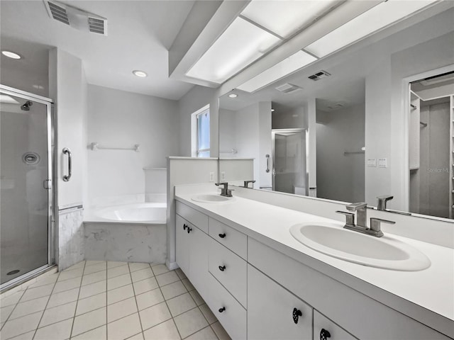 bathroom featuring vanity, shower with separate bathtub, and tile patterned flooring