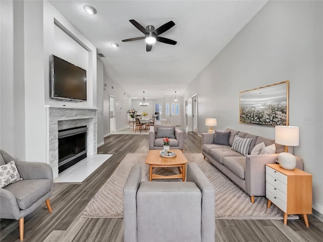 living room with hardwood / wood-style floors and ceiling fan