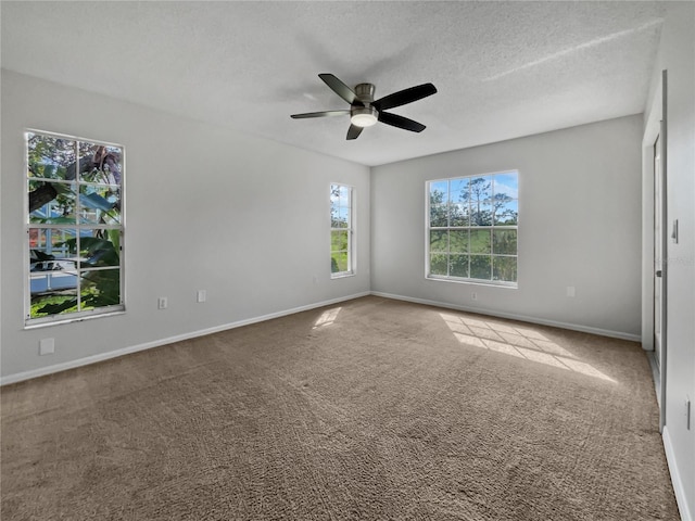 carpeted spare room with a textured ceiling and ceiling fan