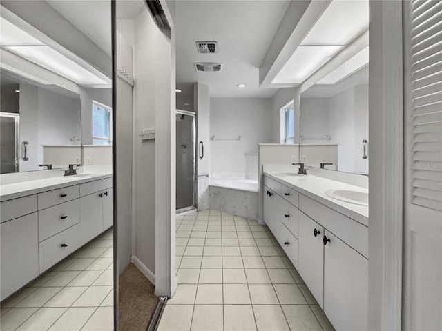 bathroom featuring vanity, plus walk in shower, and tile patterned flooring