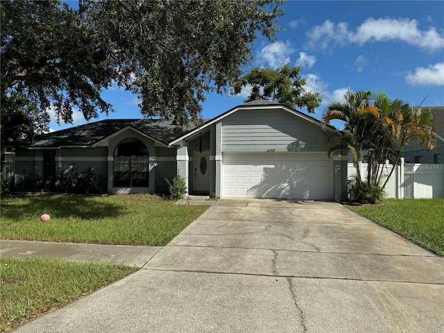 ranch-style house featuring a front yard and a garage