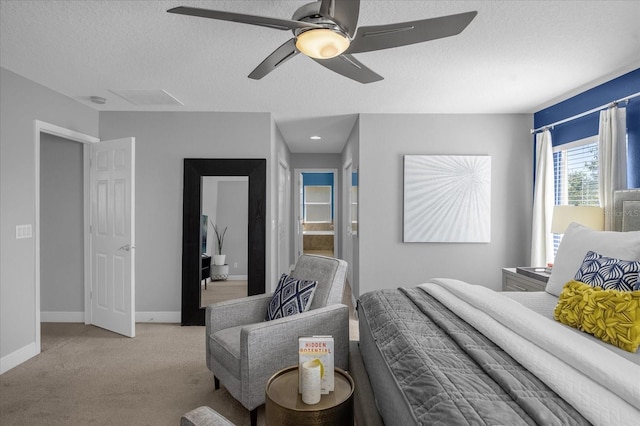 carpeted bedroom with a textured ceiling and ceiling fan