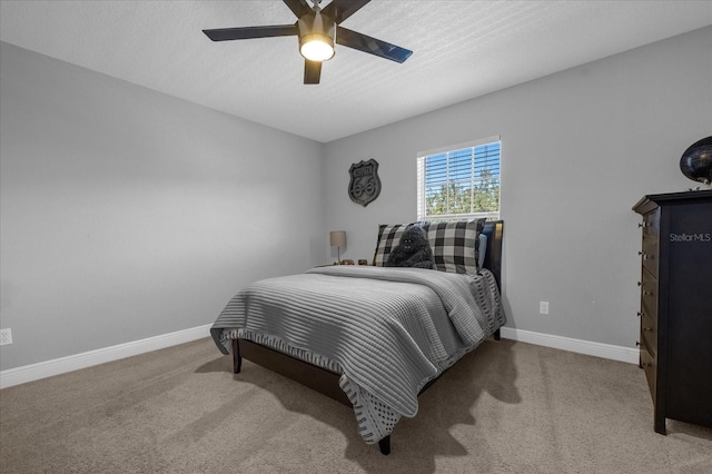 carpeted bedroom with a textured ceiling and ceiling fan