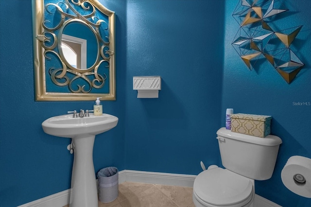 bathroom with toilet and tile patterned flooring