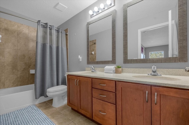 full bathroom featuring a textured ceiling, toilet, tile patterned floors, vanity, and shower / tub combo with curtain