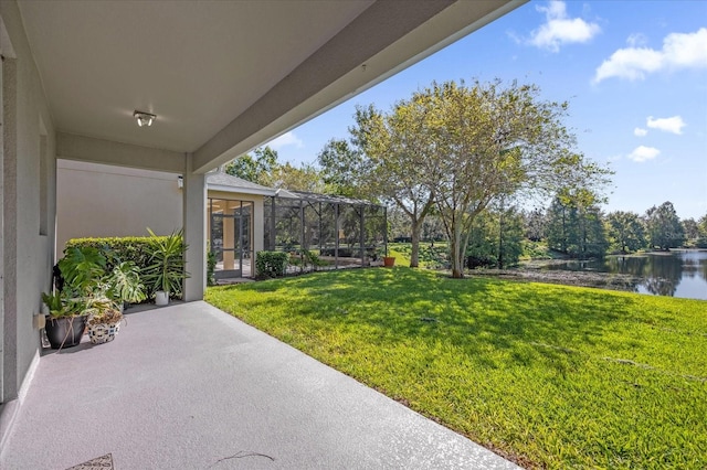 view of yard featuring a lanai and a water view