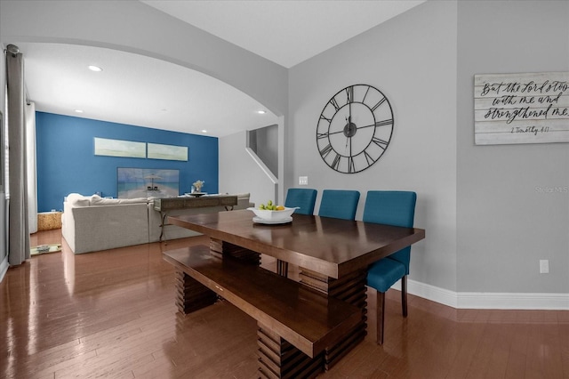 dining area with arched walkways, baseboards, hardwood / wood-style floors, and recessed lighting