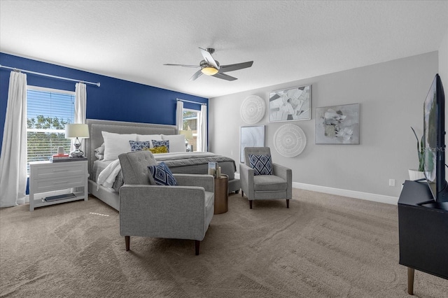 carpeted bedroom with a ceiling fan, a textured ceiling, and baseboards