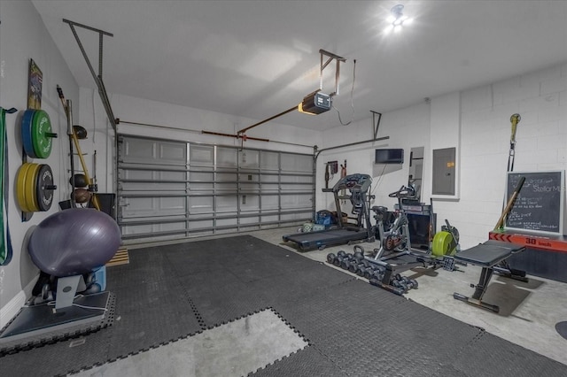 garage with a garage door opener, concrete block wall, and electric panel