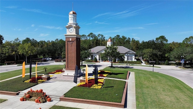 view of property's community with a lawn