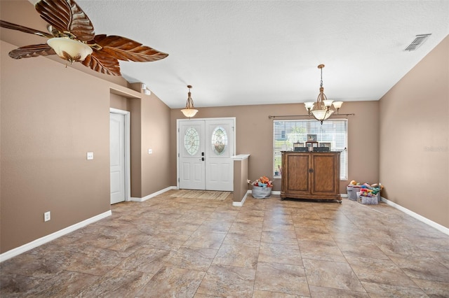 foyer with ceiling fan with notable chandelier