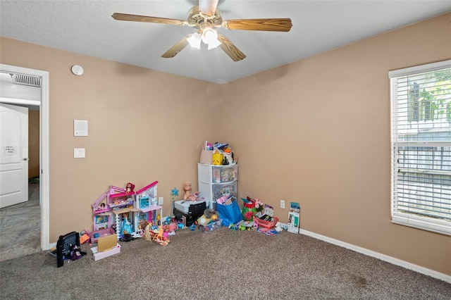 rec room with ceiling fan and carpet flooring