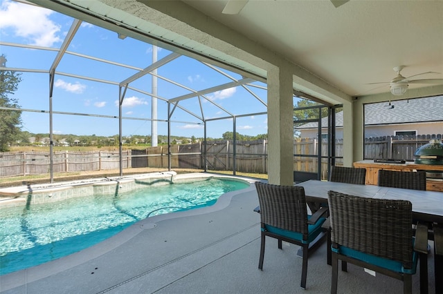 view of swimming pool featuring a patio, glass enclosure, and ceiling fan