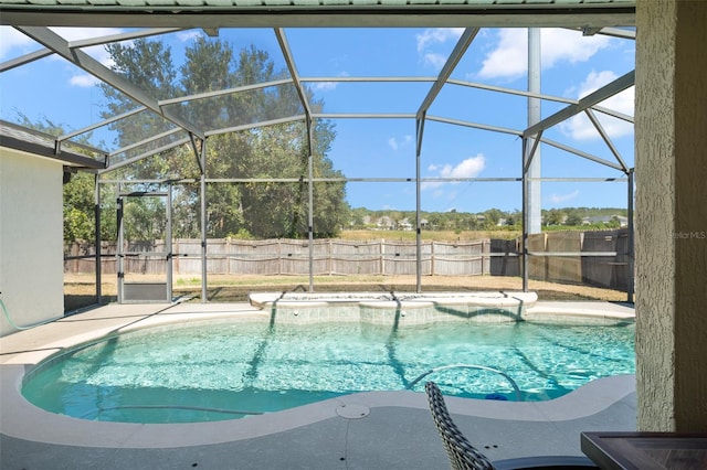 view of swimming pool featuring a patio area and glass enclosure