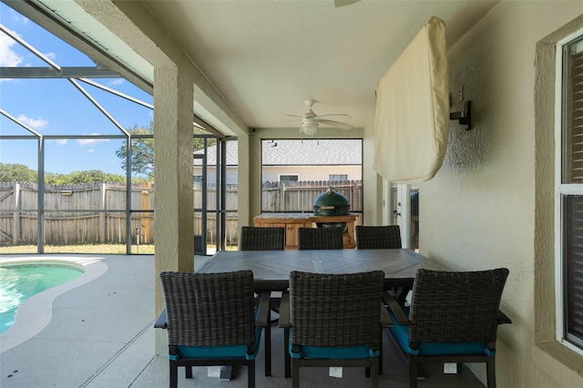 sunroom / solarium featuring ceiling fan and a swimming pool