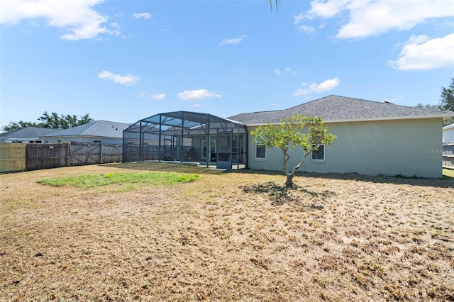 back of house featuring glass enclosure