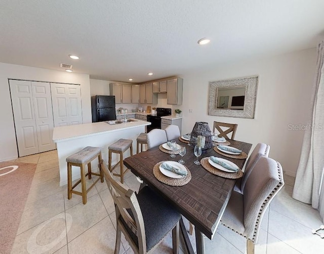 dining area with light tile patterned floors and sink