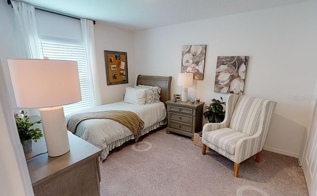 bedroom featuring light carpet