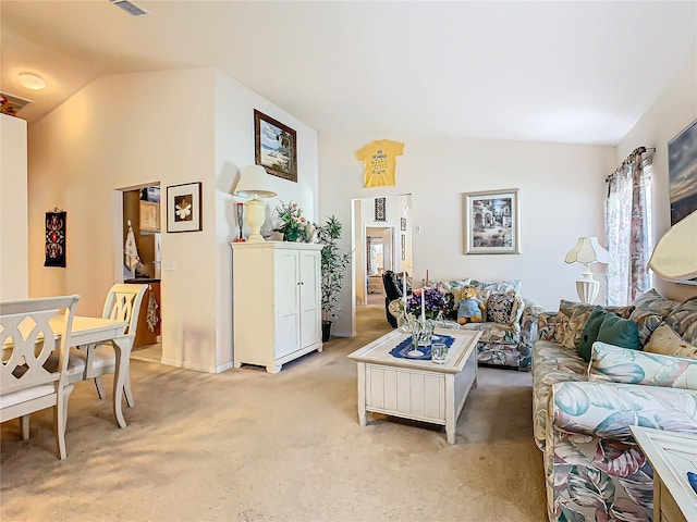 living room with lofted ceiling and light colored carpet