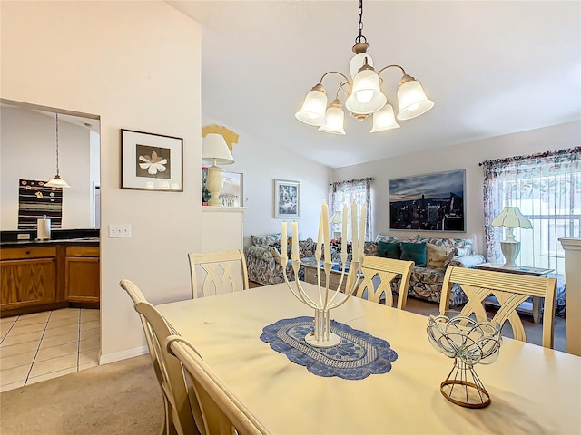 dining area featuring a notable chandelier, vaulted ceiling, and light colored carpet