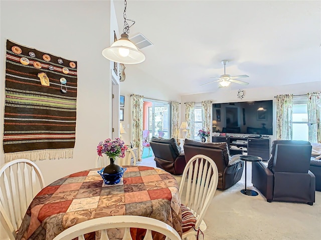 dining space with vaulted ceiling, carpet floors, and ceiling fan