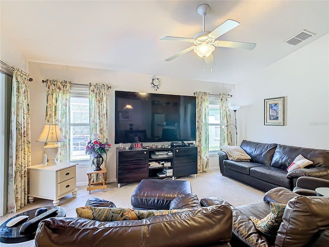 carpeted living room featuring ceiling fan