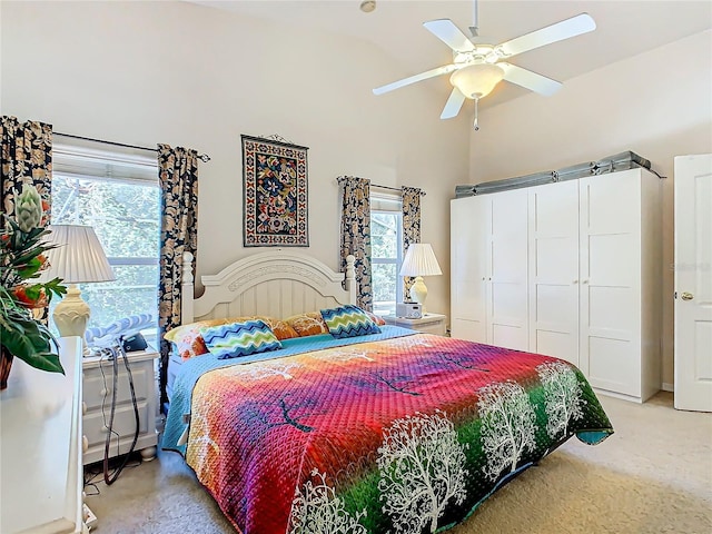 carpeted bedroom featuring multiple windows, a closet, and ceiling fan