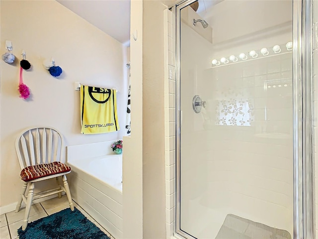 bathroom featuring independent shower and bath and tile patterned flooring