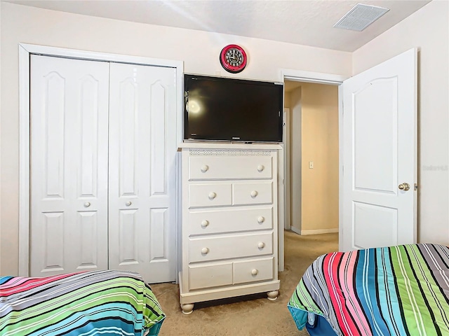 carpeted bedroom with a closet